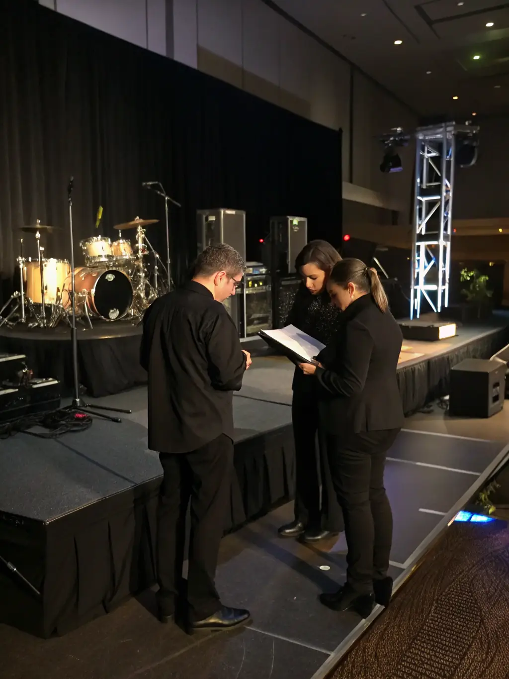 A team coordinating a performance event with schedules and venue arrangements, illustrating ACPR's organizational facilitation.